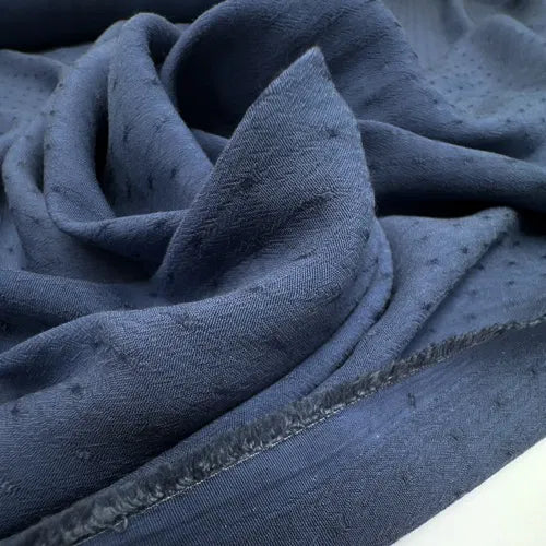 Close-up of Dressweight Twill fabric in textured blue, made from a premium blend of 75% Viscose/Rayon and 25% Cotton, perfect for stylish shirts and blouses.