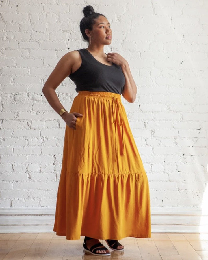 True Bias Mave Skirt sewing pattern in drapey fabric, featuring elastic waistband, inseam pockets, and optional ruffle hem in multiple lengths.