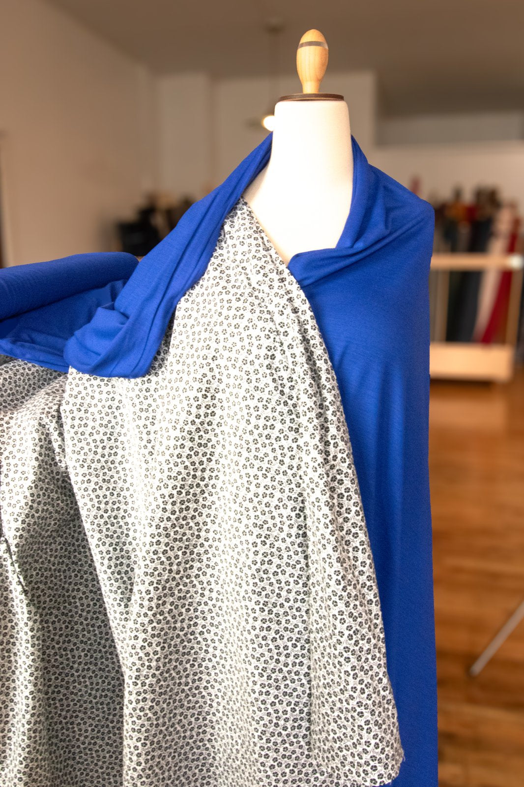 Close-up texture of monochrome floral stretch poplin showing botanical pattern detail

