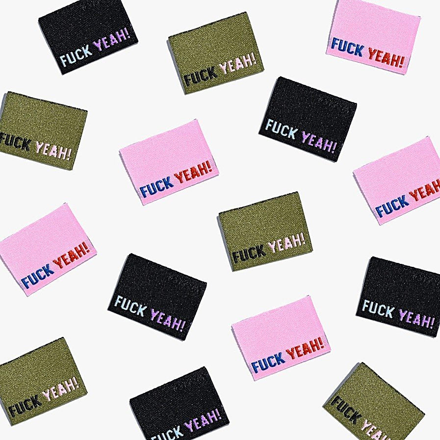 F*ck Yeah woven labels by Kylie and the Machine showing three color variations: black/blue/purple, khaki/black/pink, and pink/navy/rust side seam tags