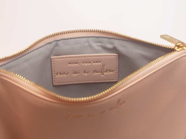 Everyday wristlet clutch in neutral color with removable strap and minimalist design.