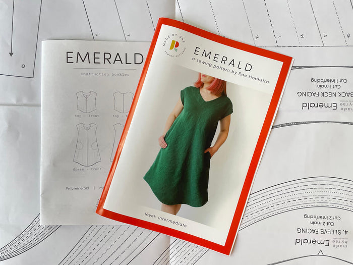 Made By Rae Emerald Dress pattern featuring a V-shaped neckline, curved hem, and optional pockets