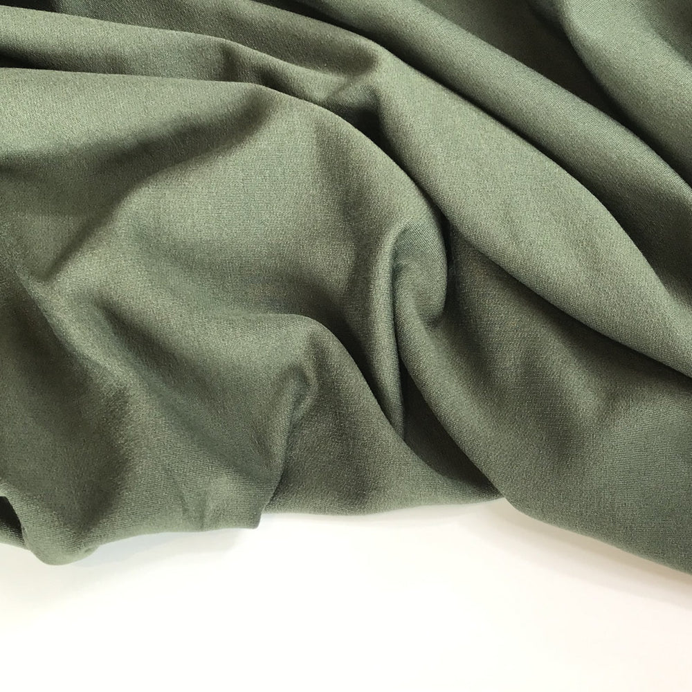 Deep olive sweatshirt fleece fabric with soft texture and rich color, perfect for cozy layered garments

