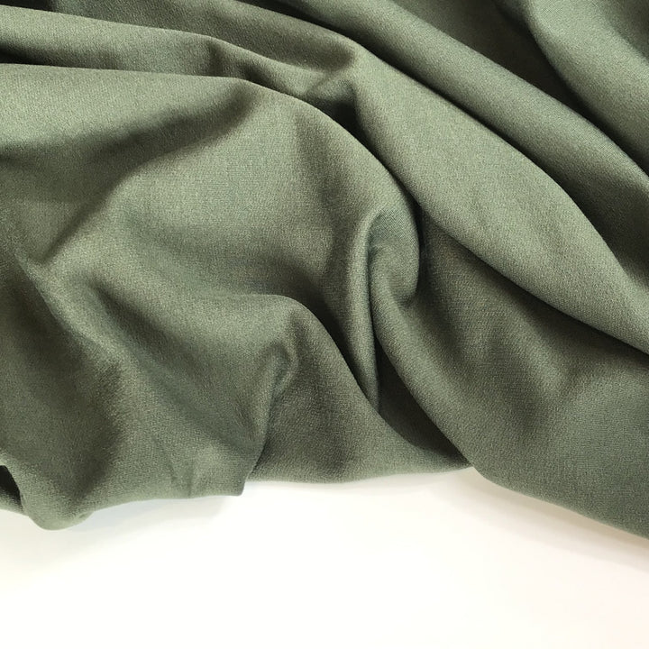 Deep olive sweatshirt fleece fabric with soft texture and rich color, perfect for cozy layered garments

