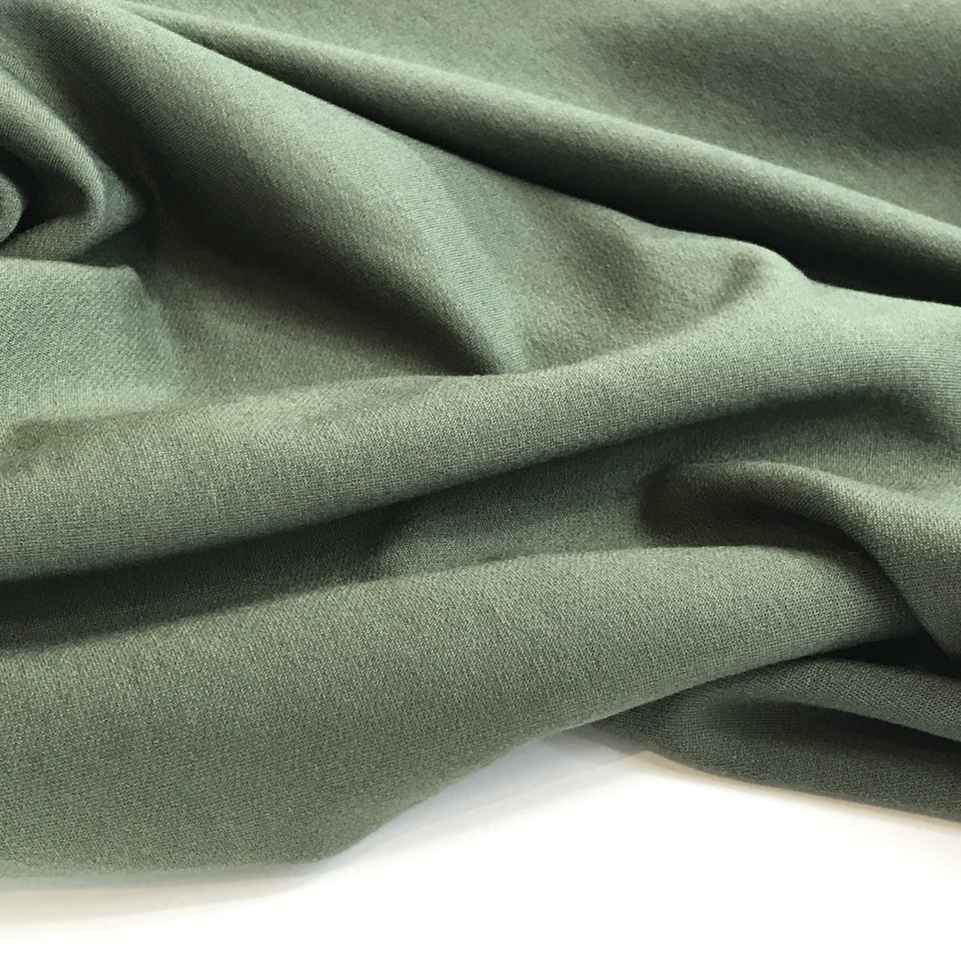 Deep olive sweatshirt fleece fabric with soft texture and rich color, perfect for cozy layered garments

