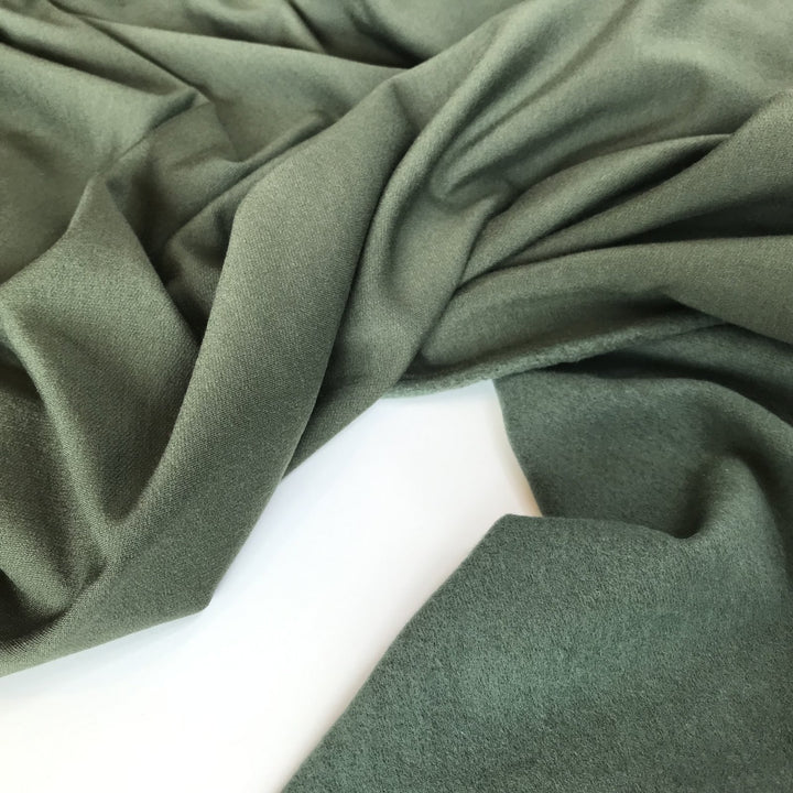 Deep olive sweatshirt fleece fabric with soft texture and rich color, perfect for cozy layered garments

