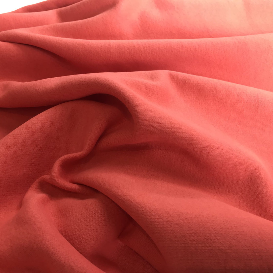 Coral Sweatshirt Brushed Fleece fabric with soft brushed texture and fluffy back, ideal for cozy apparel

