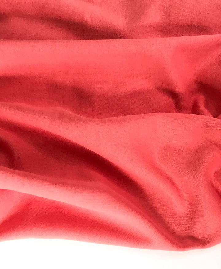 Coral Sweatshirt Brushed Fleece fabric with soft brushed texture and fluffy back, ideal for cozy apparel

