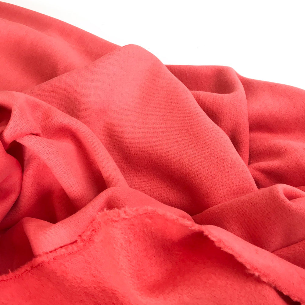 Coral Sweatshirt Brushed Fleece fabric with soft brushed texture and fluffy back, ideal for cozy apparel

