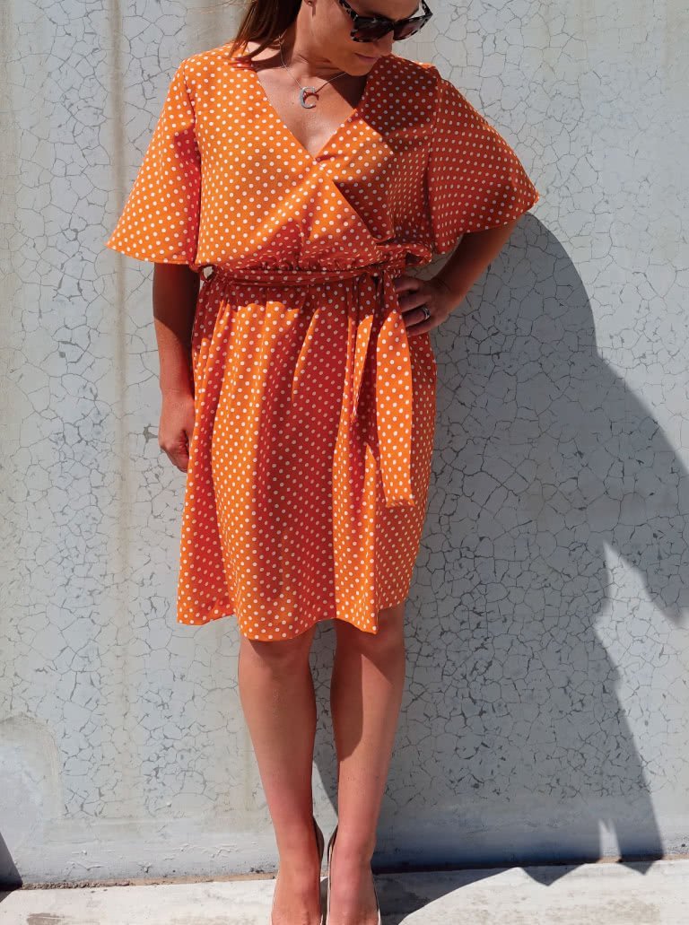 Style Arc Bonita Dress sewing pattern with wrap front, fluted sleeves, and tie belt design