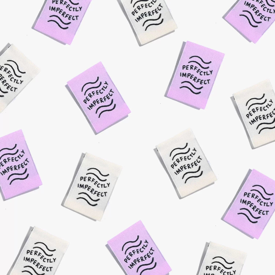 New 'Perfectly Imperfect' woven labels by Kylie and the Machine in lilac and ivory vaporwave colors - vertical end fold tags celebrating handmade beauty