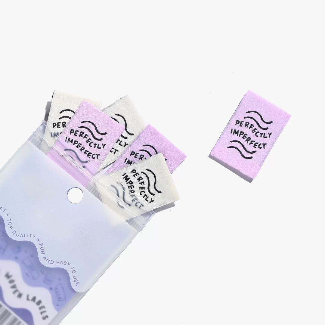 New 'Perfectly Imperfect' woven labels by Kylie and the Machine in lilac and ivory vaporwave colors - vertical end fold tags celebrating handmade beauty