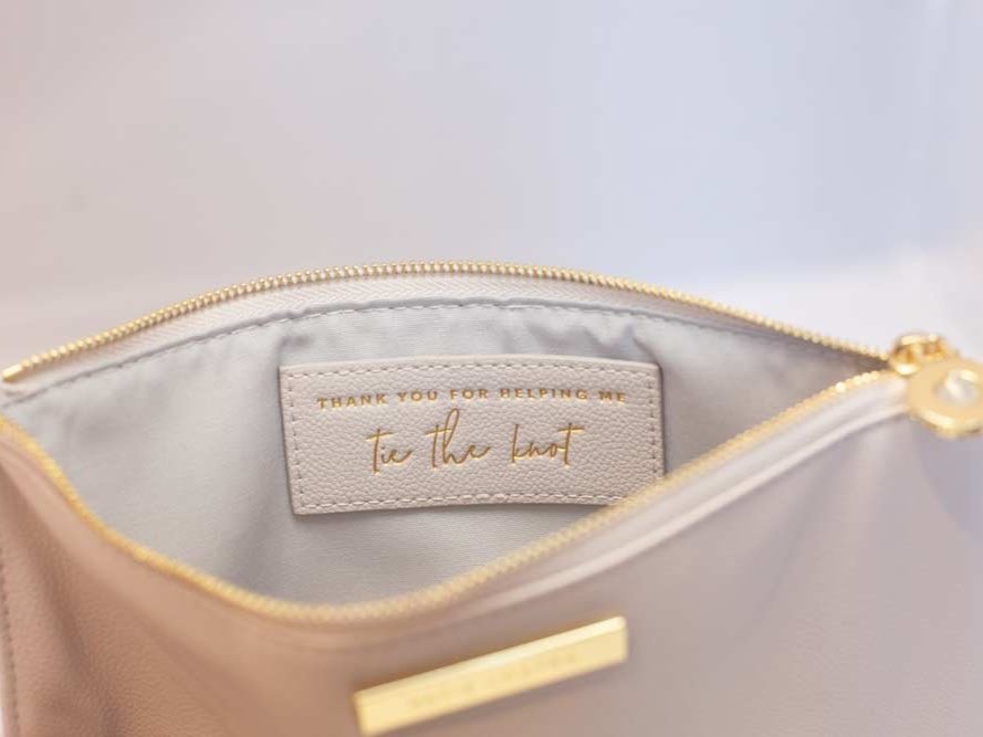 Katie Loxton Message Clutch in elegant design with zipper closure, available in multiple colors.
