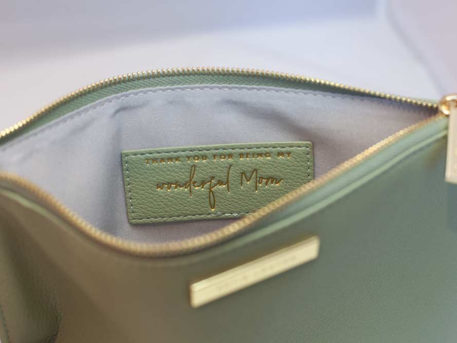 Katie Loxton Message Clutch in elegant design with zipper closure, available in multiple colors.