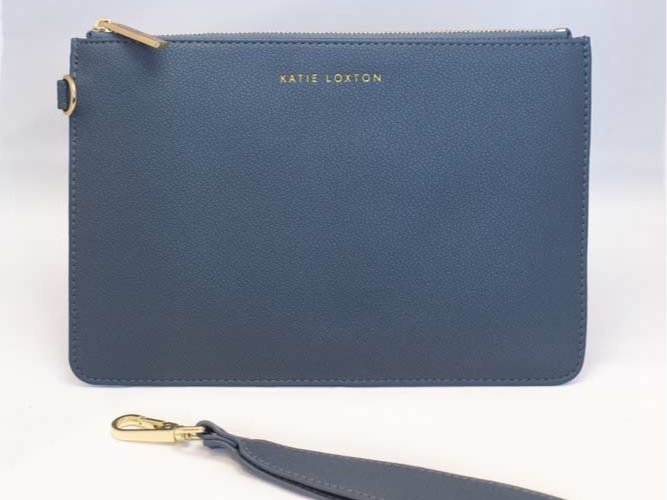 Everyday wristlet clutch in neutral color with removable strap and minimalist design.