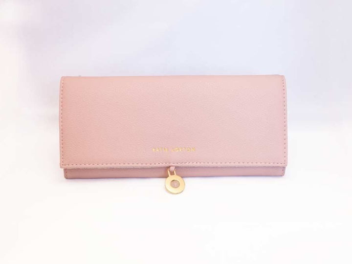 Travel Jewelry Organizer Roll in soft pink and navy faux-leather with compartments for rings, necklaces, and earrings.