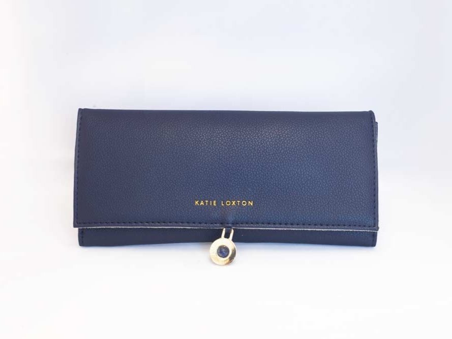 Travel Jewelry Organizer Roll in soft pink and navy faux-leather with compartments for rings, necklaces, and earrings.