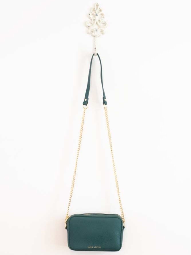Millie Mini Crossbody handbag in vibrant green vegan leather with gold-tone hardware and delicate chain strap.