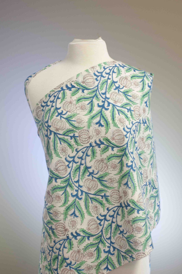 White botanical printed cotton fabric with blue green vines and vegetable blooms