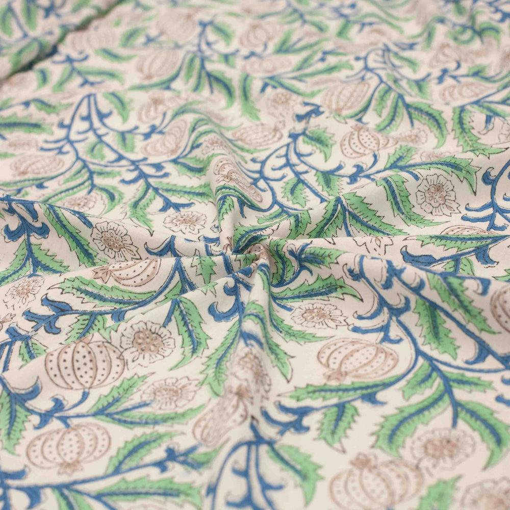 White botanical printed cotton fabric with blue green vines and vegetable blooms