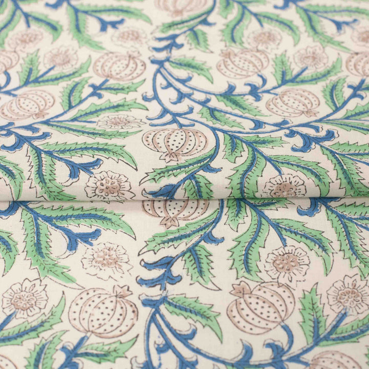 White botanical printed cotton fabric with blue green vines and vegetable blooms