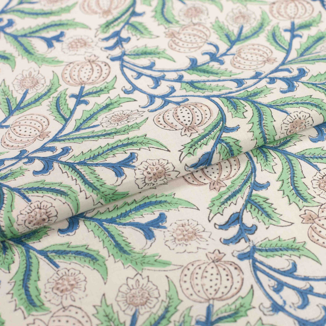 White botanical printed cotton fabric with blue green vines and vegetable blooms
