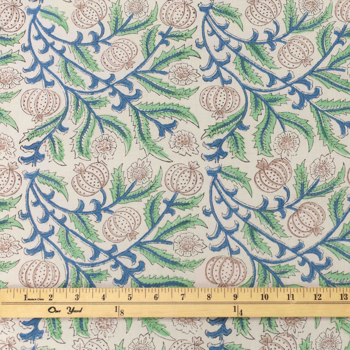White botanical printed cotton fabric with blue green vines and vegetable blooms