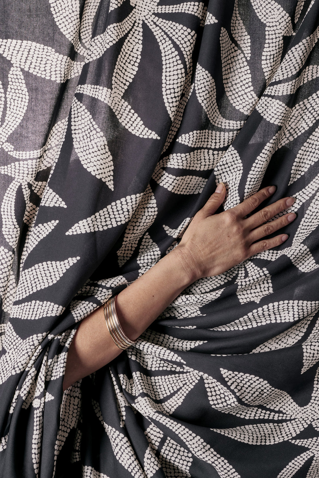 Viscose Challis fabric in deep charcoal with white leaf print, lightweight 55-inch wide textile for dresses, skirts, and blouses