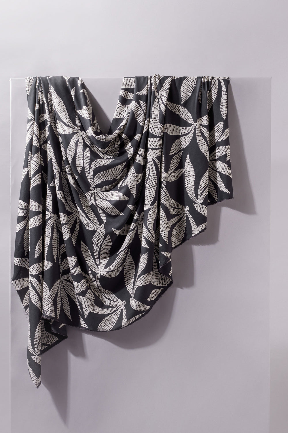 Viscose Challis fabric in deep charcoal with white leaf print, lightweight 55-inch wide textile for dresses, skirts, and blouses