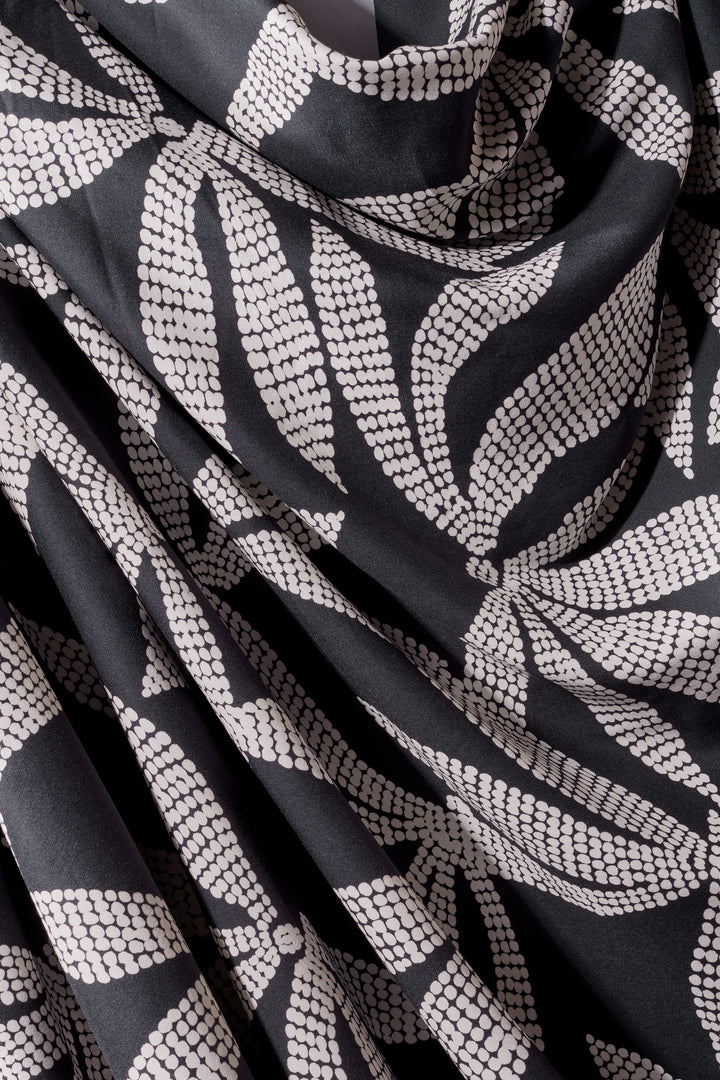 Viscose Challis fabric in deep charcoal with white leaf print, lightweight 55-inch wide textile for dresses, skirts, and blouses