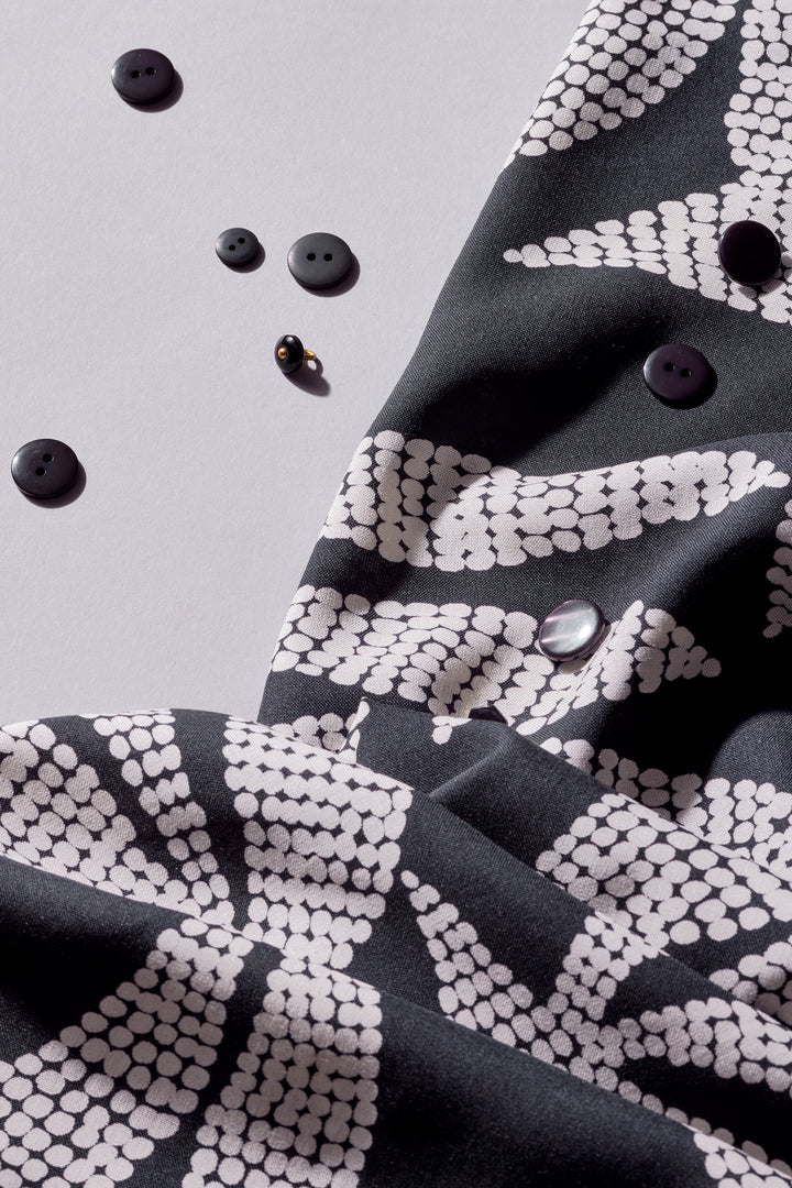 Viscose Challis fabric in deep charcoal with white leaf print, lightweight 55-inch wide textile for dresses, skirts, and blouses