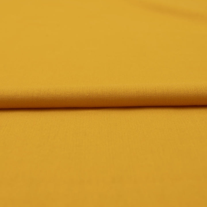 Laundered linen fabric in marigold – 100% linen, 6 oz medium weight, pre-washed, 58 inches wide, soft drape for dresses and tops