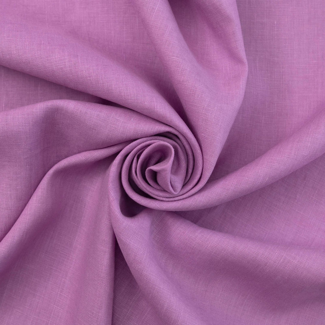 Fresh lilac linen fabric with soft drape, breathable lightweight texture, ideal for sewing dresses, skirts, blouses, and summer apparel.

