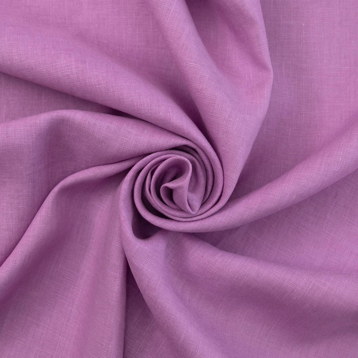 Fresh lilac linen fabric with soft drape, breathable lightweight texture, ideal for sewing dresses, skirts, blouses, and summer apparel.

