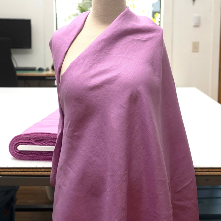 Fresh lilac linen fabric with soft drape, breathable lightweight texture, ideal for sewing dresses, skirts, blouses, and summer apparel.

