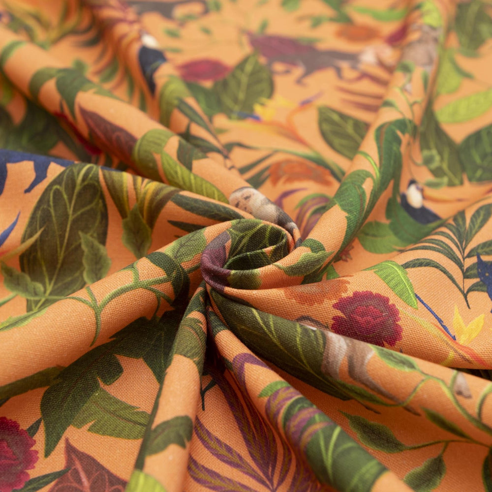 "Italian linen fabric in vibrant orange with jungle print – features monkeys, birds, and deer on lightweight linen, perfect for shirts, dresses, and skirts"

