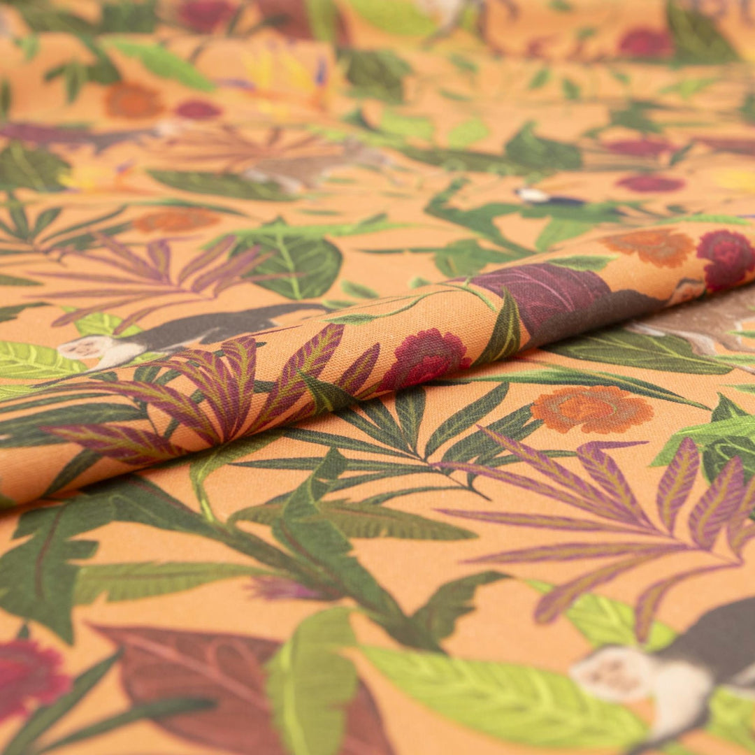 "Italian linen fabric in vibrant orange with jungle print – features monkeys, birds, and deer on lightweight linen, perfect for shirts, dresses, and skirts"

