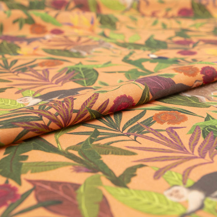 "Italian linen fabric in vibrant orange with jungle print – features monkeys, birds, and deer on lightweight linen, perfect for shirts, dresses, and skirts"

