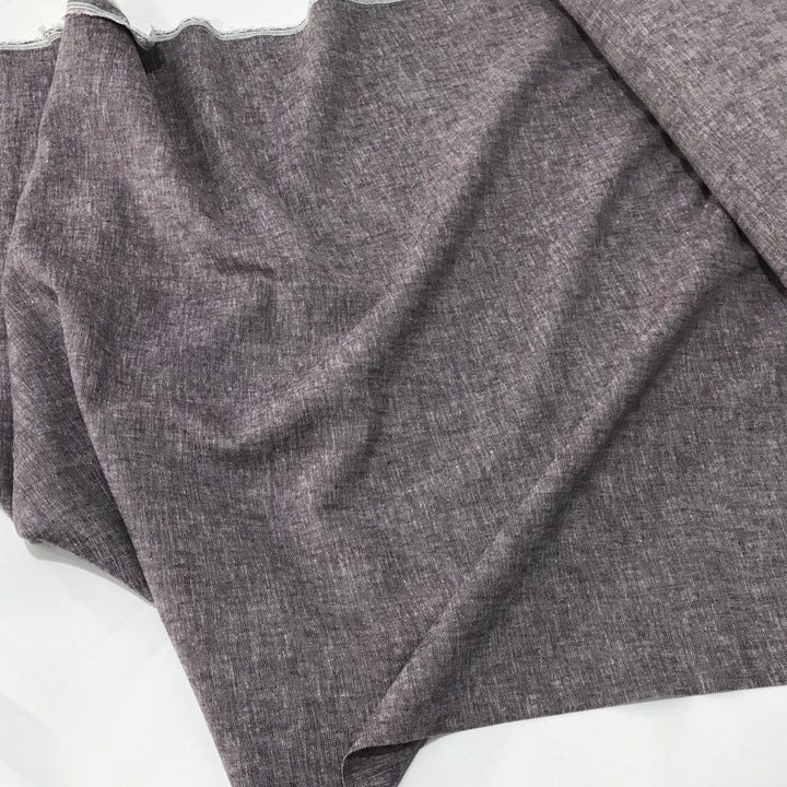 Linen rayon yarn dyed fabric in soft heliotrope purple, lightweight with subtle color texture and soft drape, ideal for dresses, tops, and skirts.

