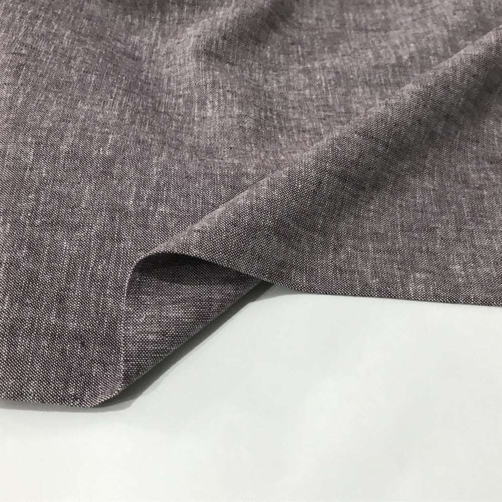 Linen rayon yarn dyed fabric in soft heliotrope purple, lightweight with subtle color texture and soft drape, ideal for dresses, tops, and skirts.

