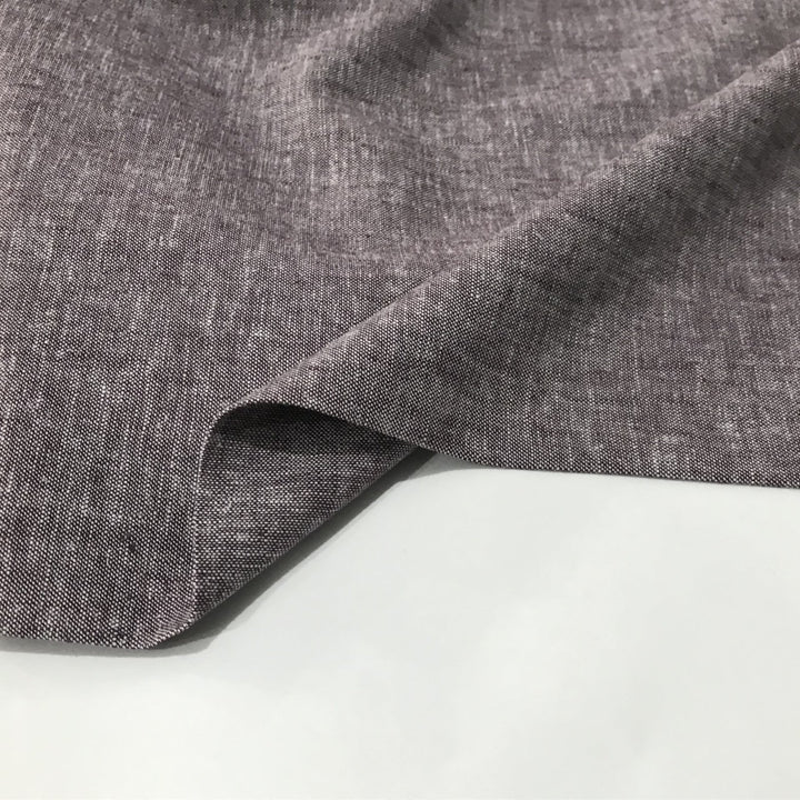 Linen rayon yarn dyed fabric in soft heliotrope purple, lightweight with subtle color texture and soft drape, ideal for dresses, tops, and skirts.


