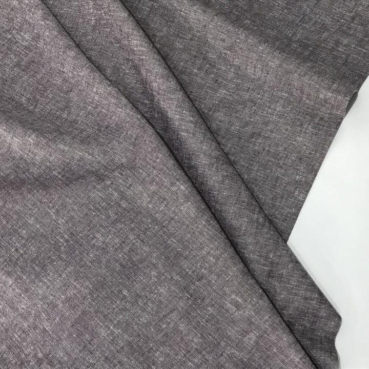 Linen rayon yarn dyed fabric in soft heliotrope purple, lightweight with subtle color texture and soft drape, ideal for dresses, tops, and skirts.


