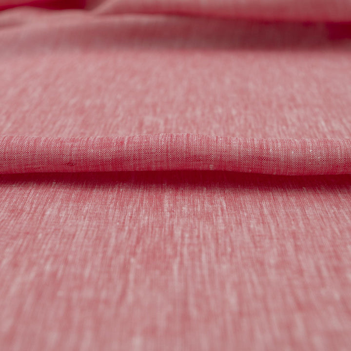 Red linen chambray fabric, lightweight and breathable, with a soft texture ideal for sewing tops, dresses, tunics, and year-round garments.


