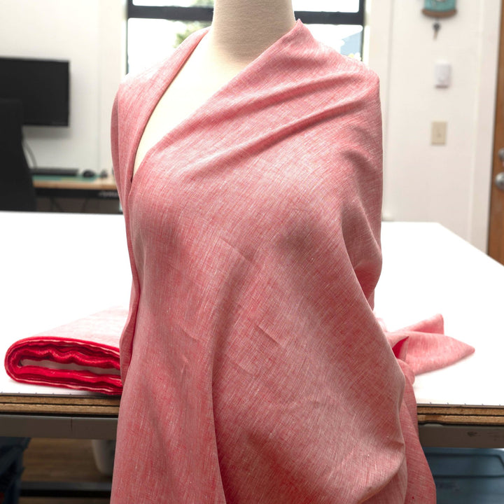 Red linen chambray fabric, lightweight and breathable, with a soft texture ideal for sewing tops, dresses, tunics, and year-round garments.

