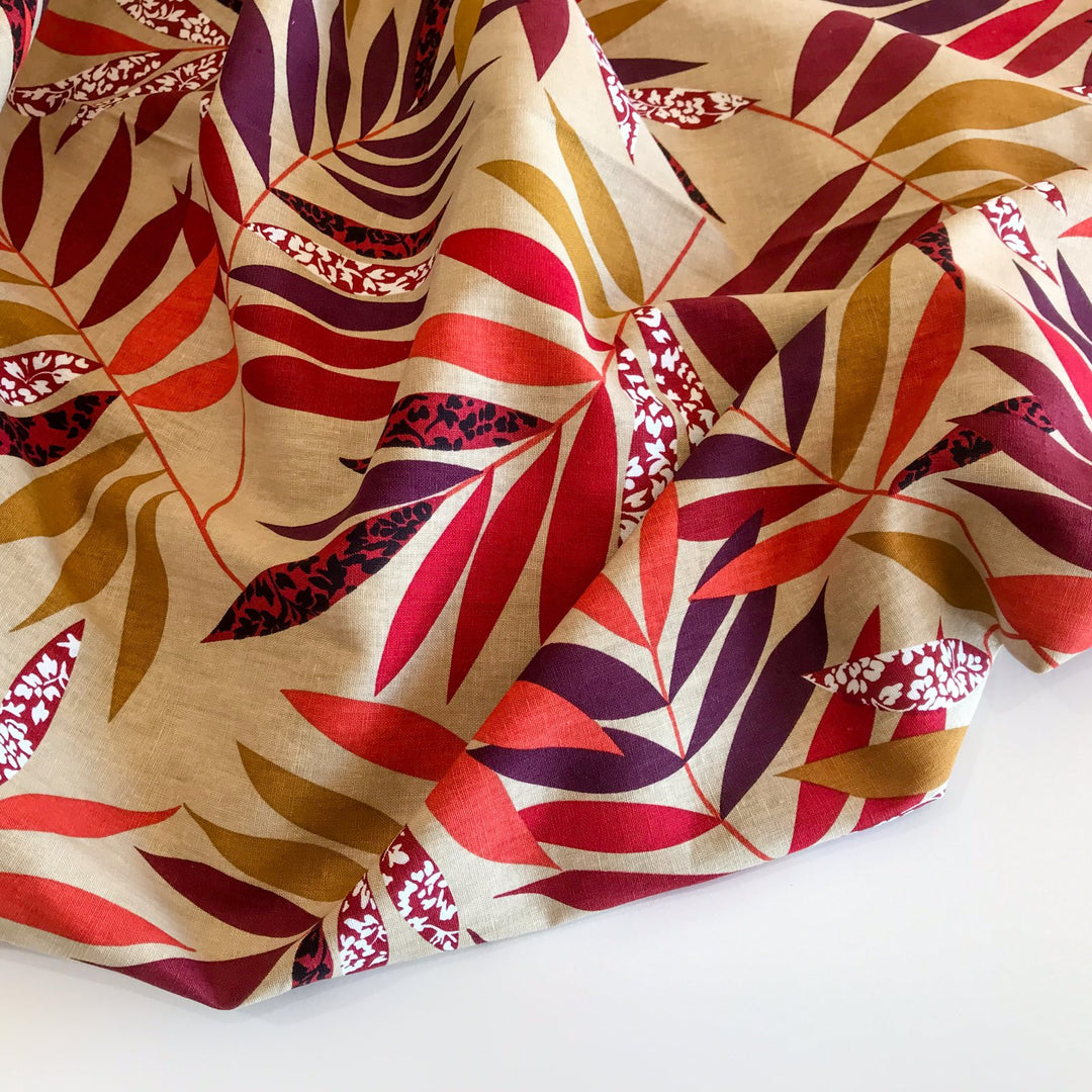 "Linen Red and Bordeaux Leaf – Soft linen fabric with autumn leaf print in burgundy, orange, maple, and purple tones"

