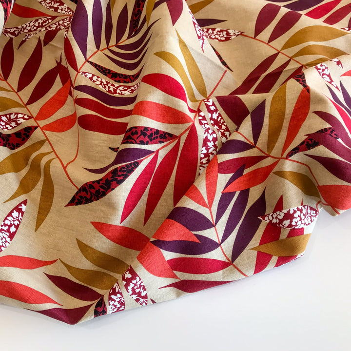 "Linen Red and Bordeaux Leaf – Soft linen fabric with autumn leaf print in burgundy, orange, maple, and purple tones"

