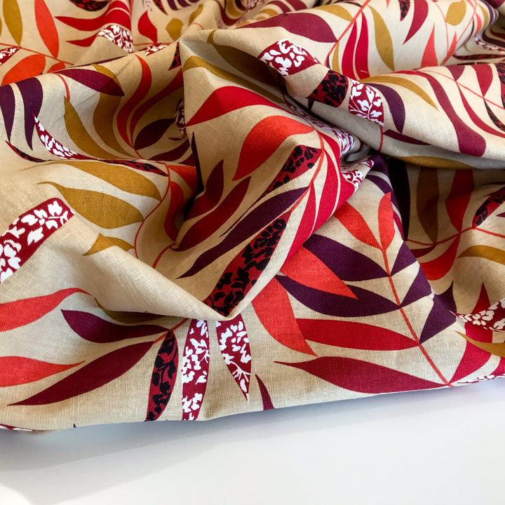 "Linen Red and Bordeaux Leaf – Soft linen fabric with autumn leaf print in burgundy, orange, maple, and purple tones"

