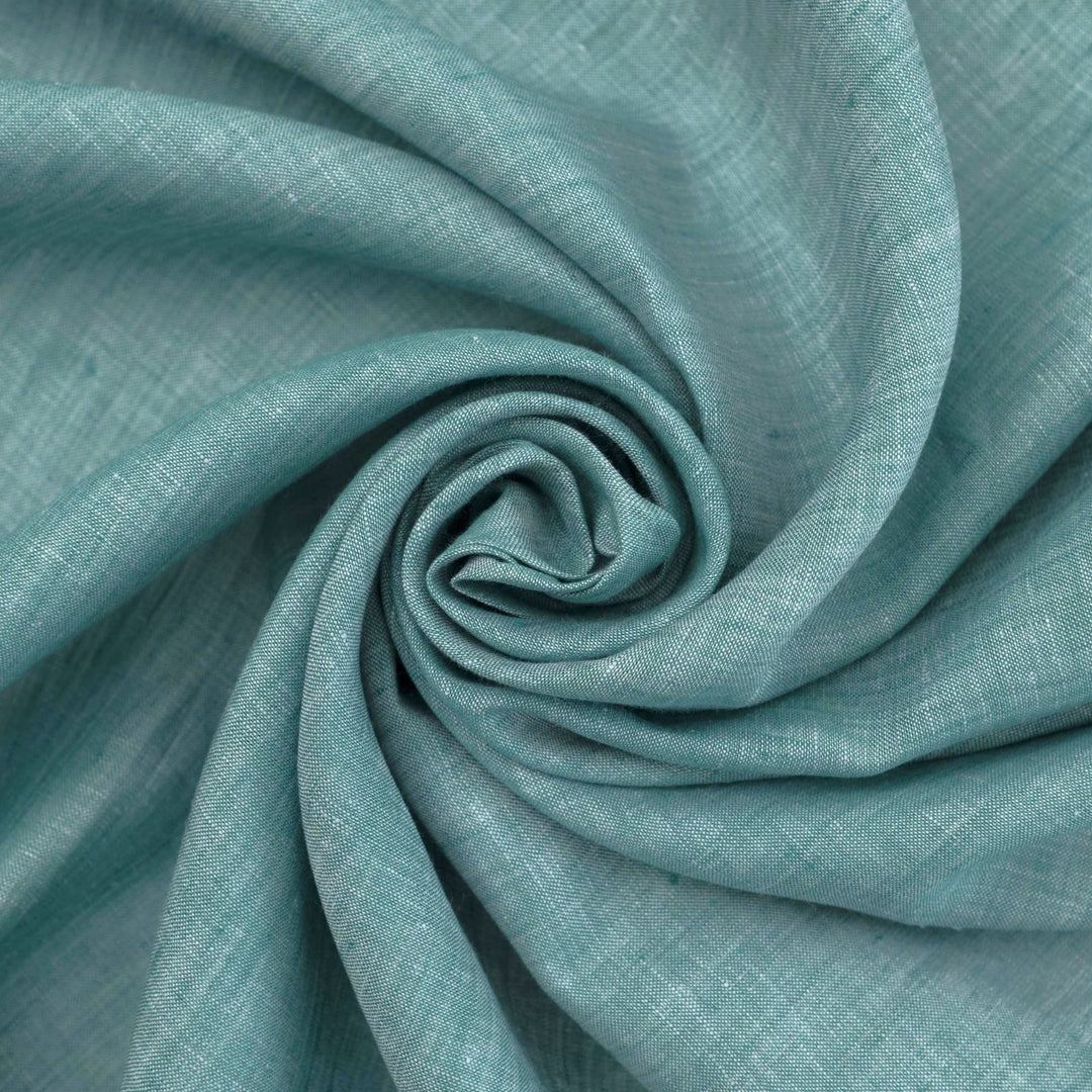 Teal linen chambray fabric, lightweight and breathable, with a soft texture ideal for sewing dresses, tunics, blouses, and year-round apparel.

