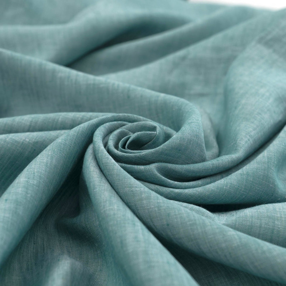 Teal linen chambray fabric, lightweight and breathable, with a soft texture ideal for sewing dresses, tunics, blouses, and year-round apparel.

