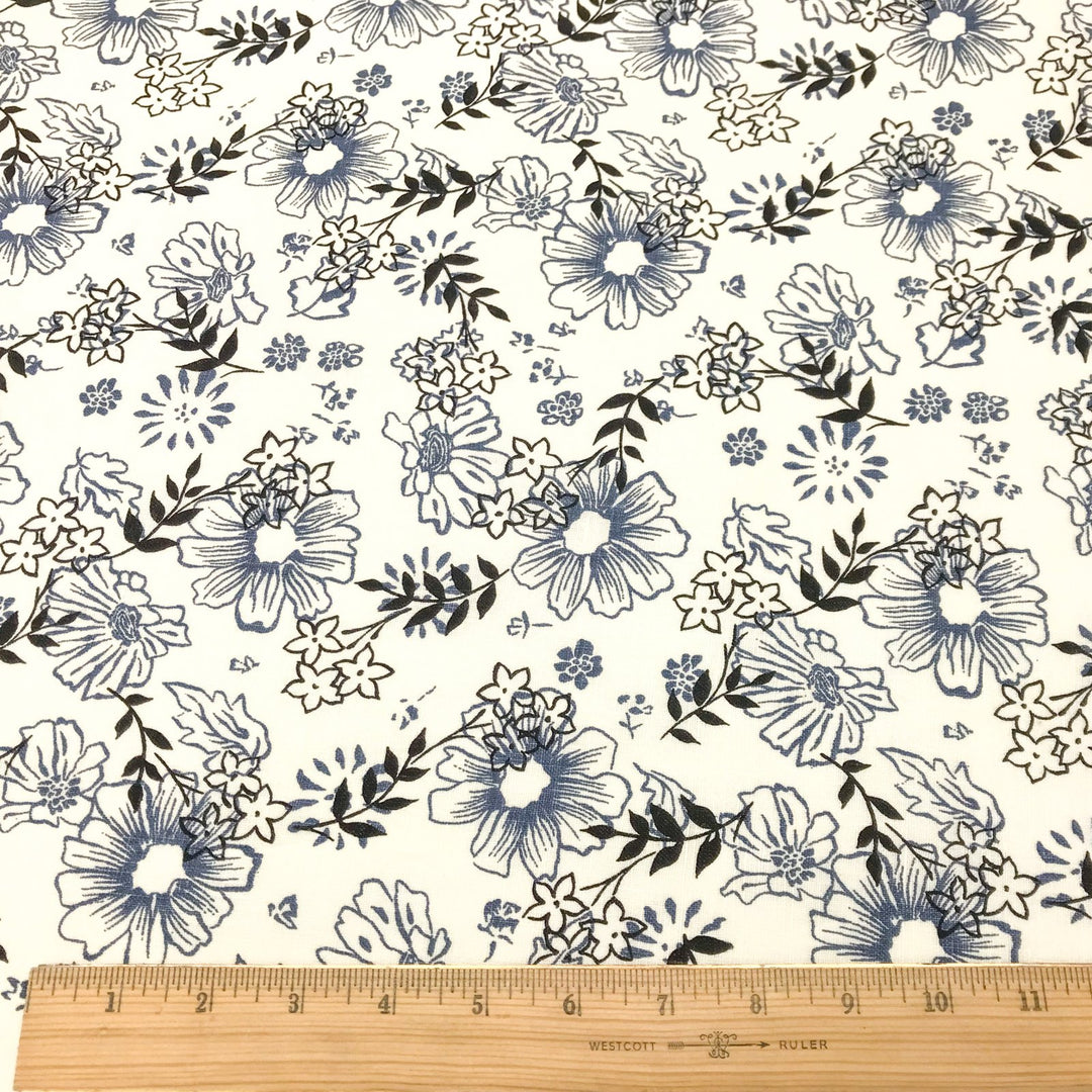"Cream linen fabric with blue and black floral print – lightweight, breathable, 100% linen for dresses, tops, and tunics."

